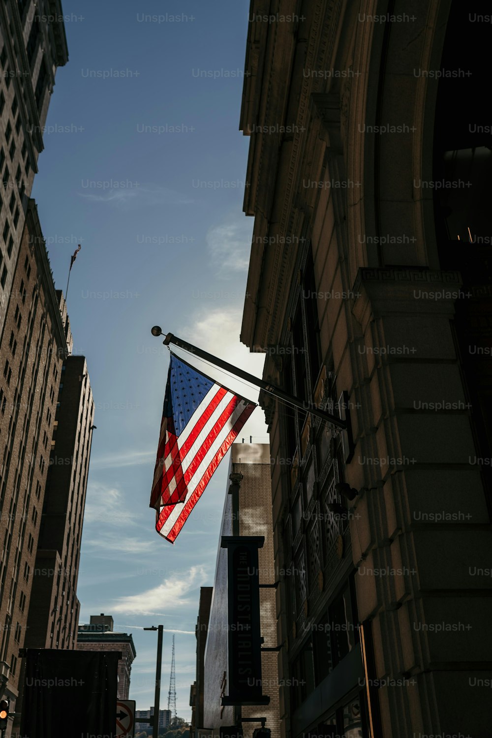 an american flag hanging from a street light