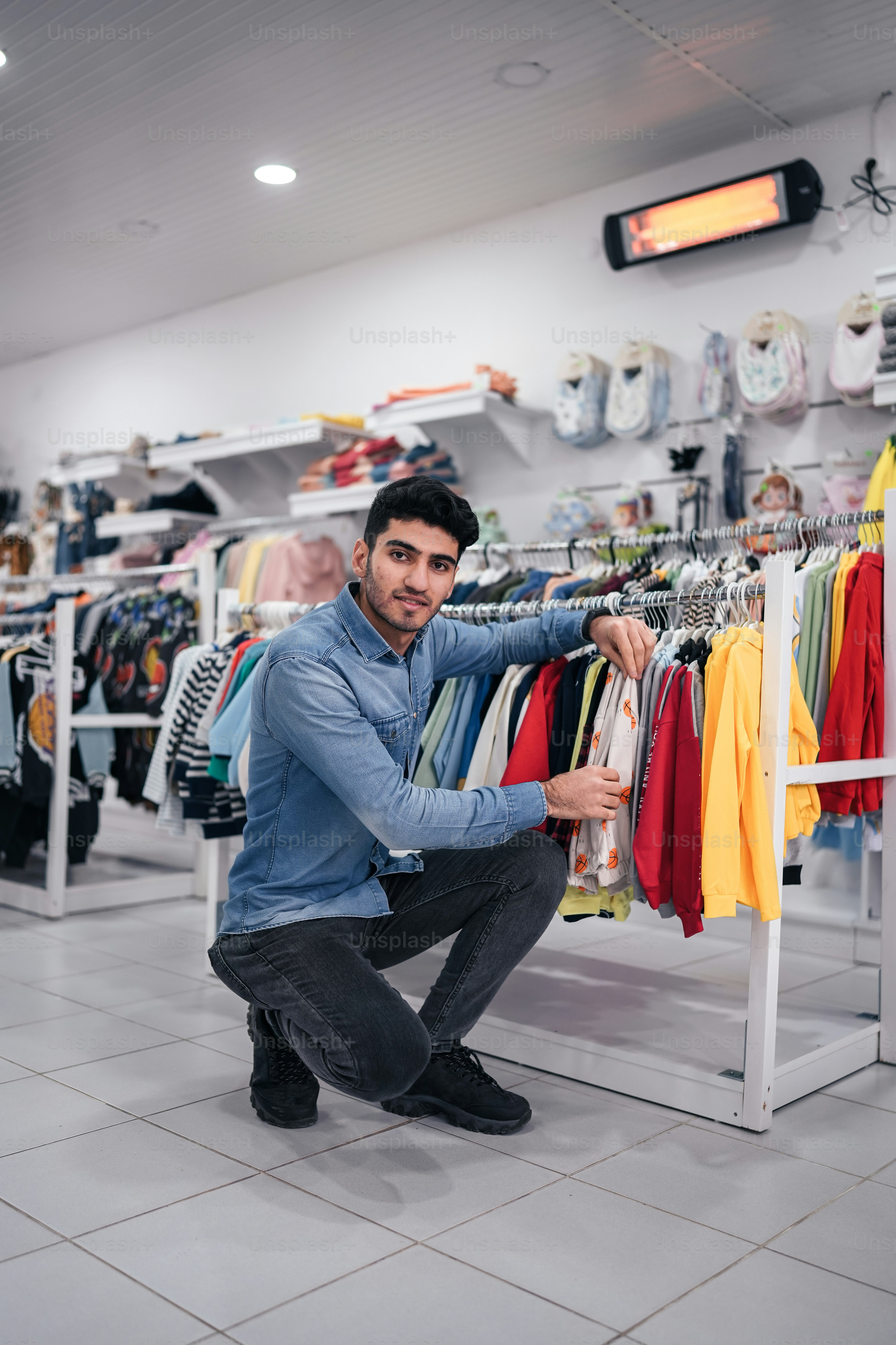 A man looking at a rack of shirts photo – Clothes Image on Unsplash
