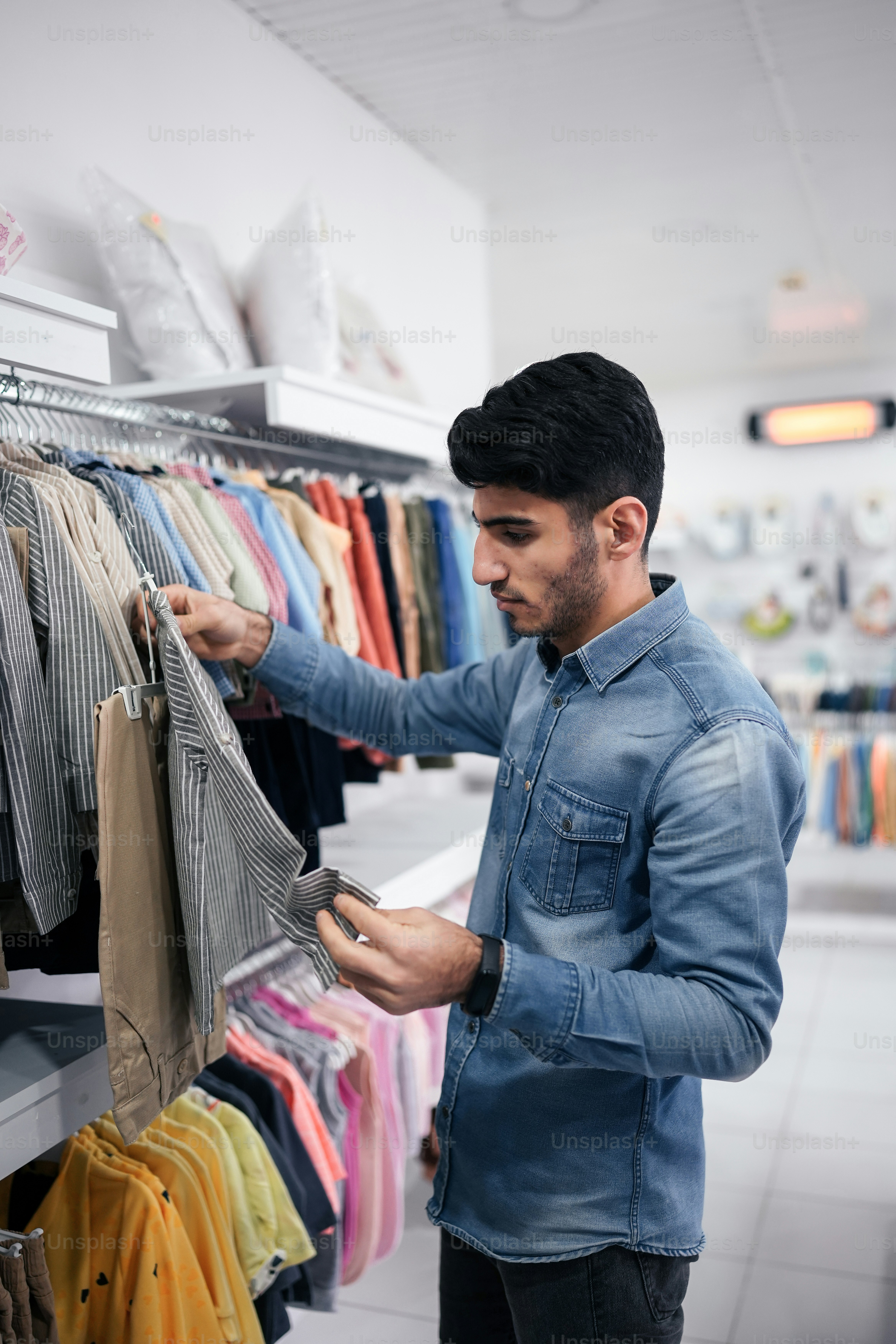 a man looking at a shirt in a store