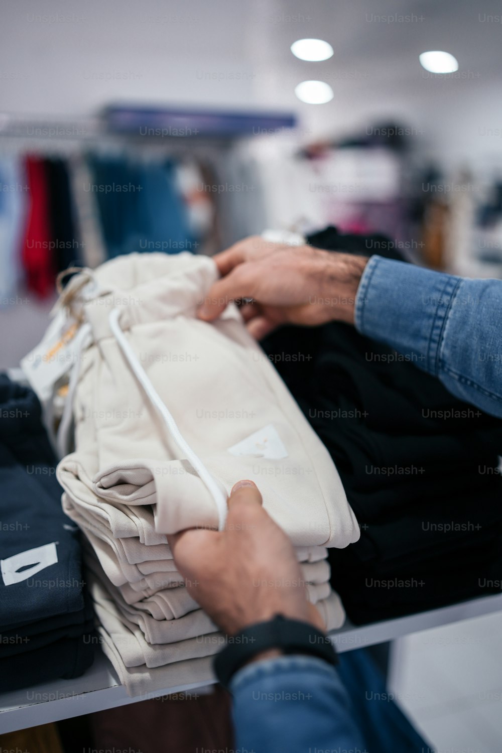 a person holding a bag of clothes in a store