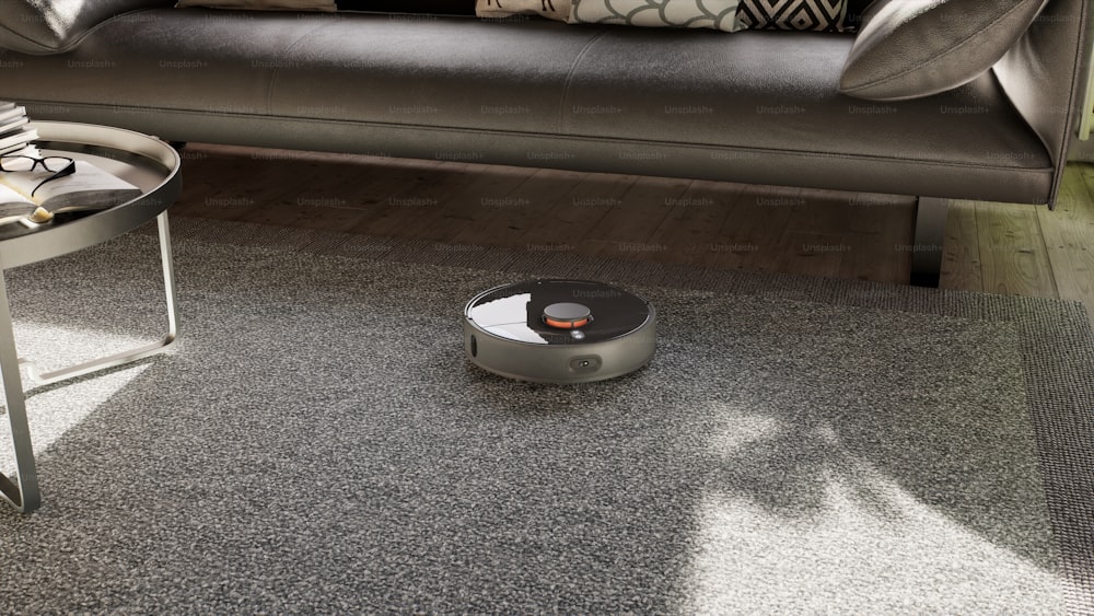 a roomba sits on the floor in front of a couch