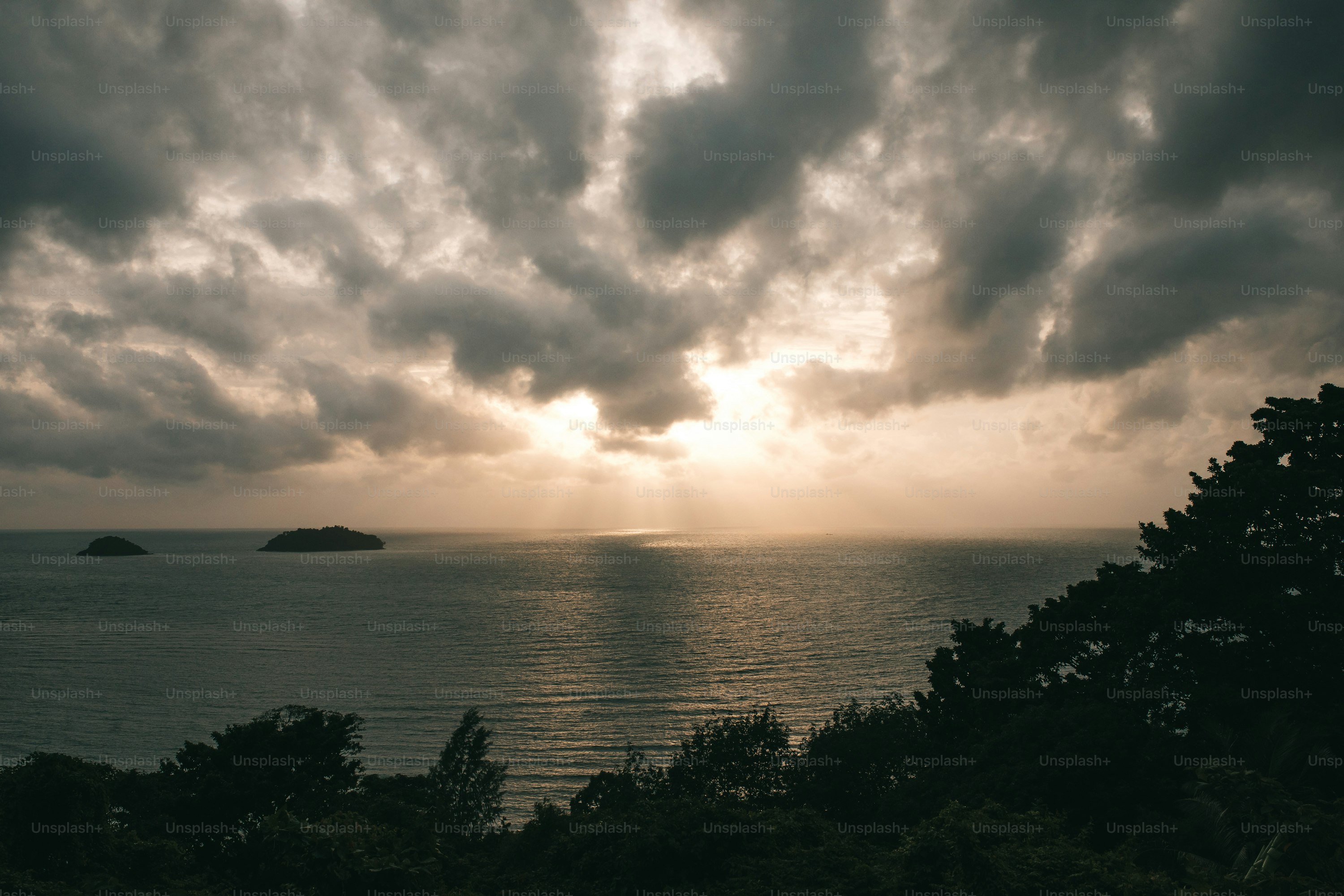 the sun is shining through the clouds over the ocean