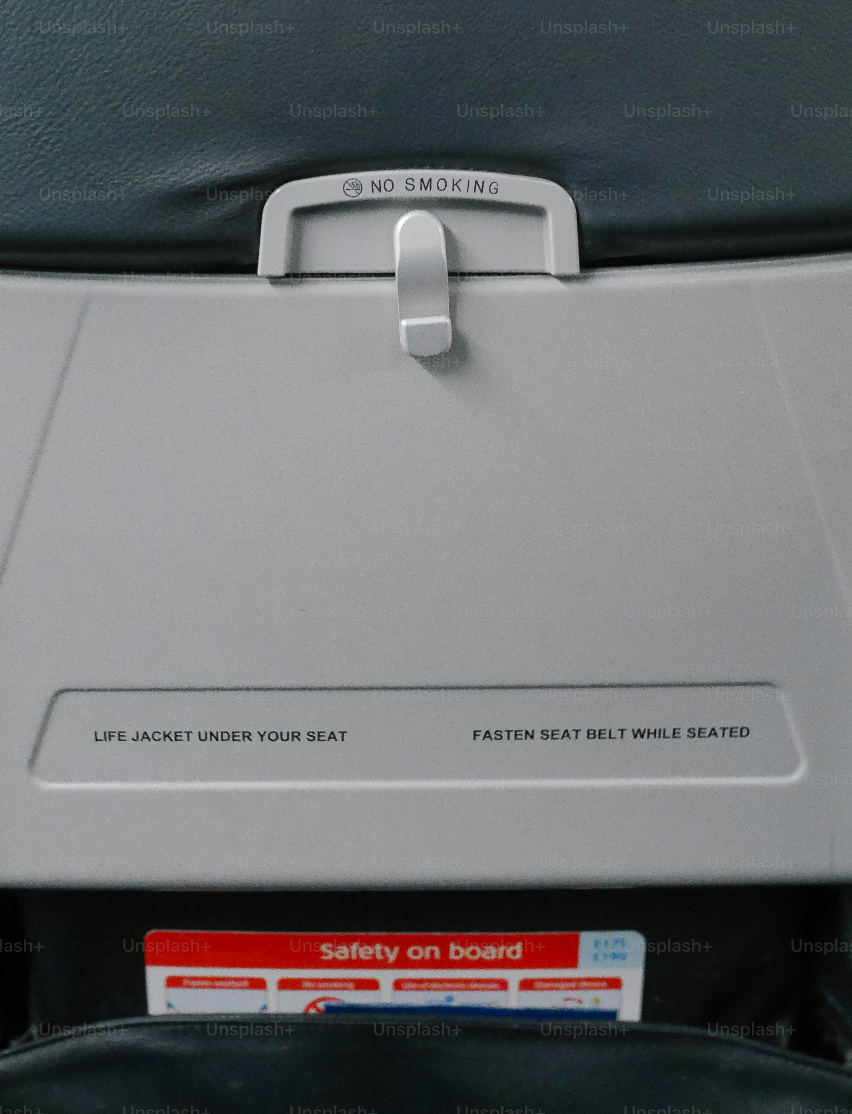 airplane seat - life jacket under your seat and fasten seat belt while seated