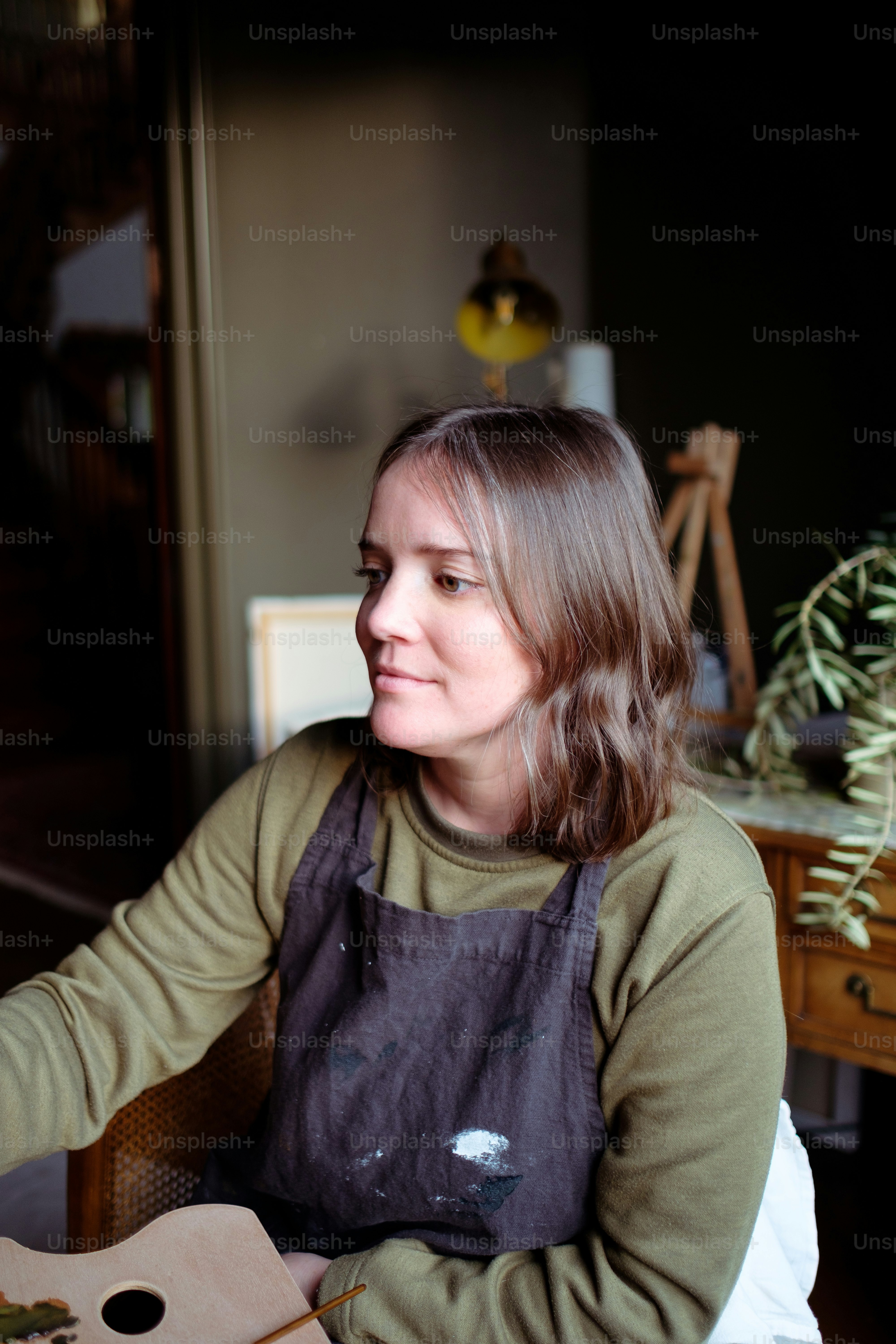 a woman sitting at a table with a pizza in front of her
