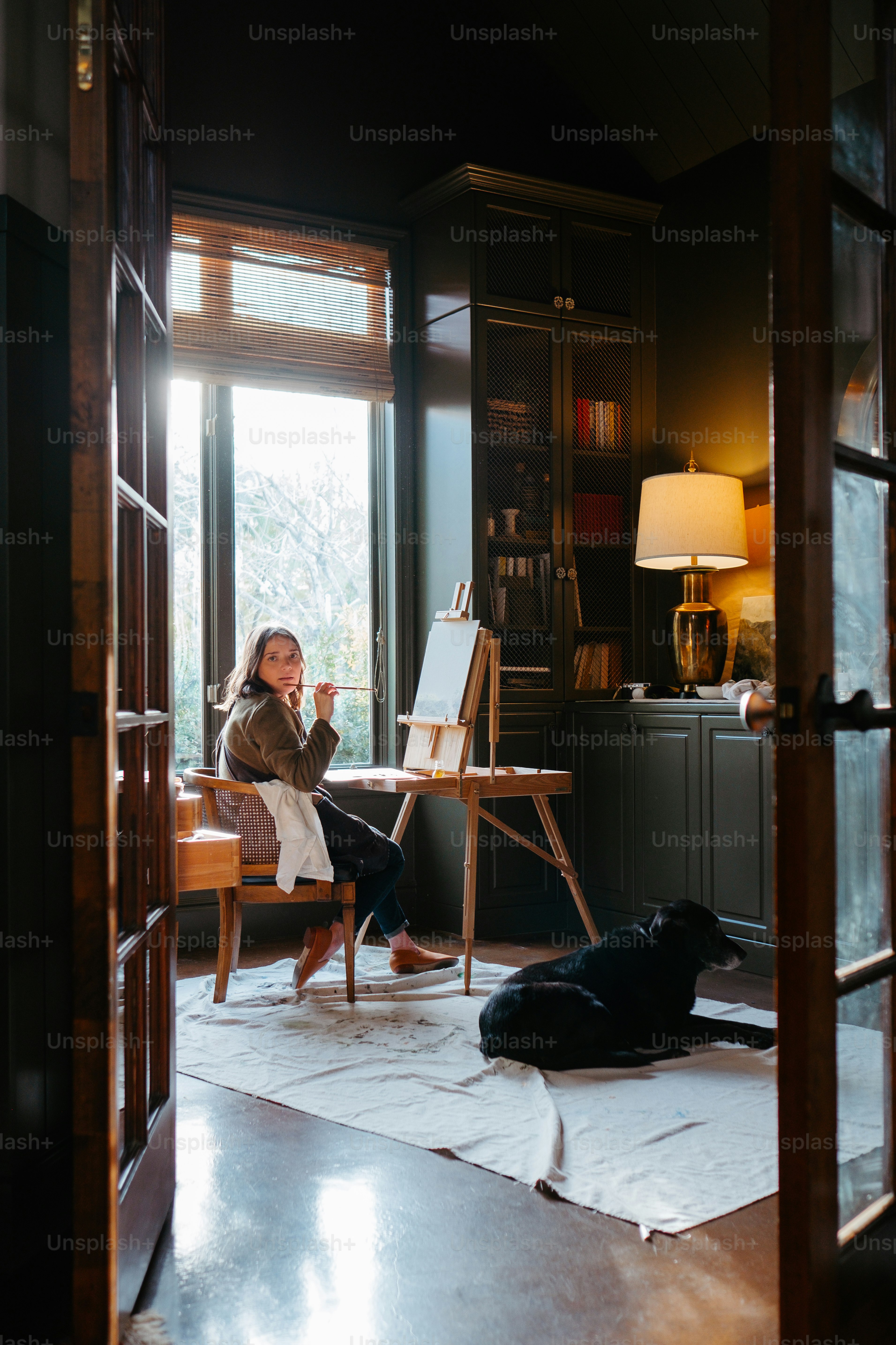 a woman sitting in a chair in front of a window