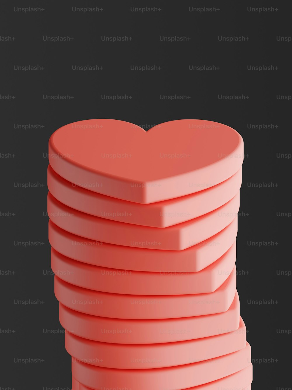 a stack of pink hearts on a black background