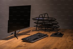 a computer monitor sitting on top of a wooden desk