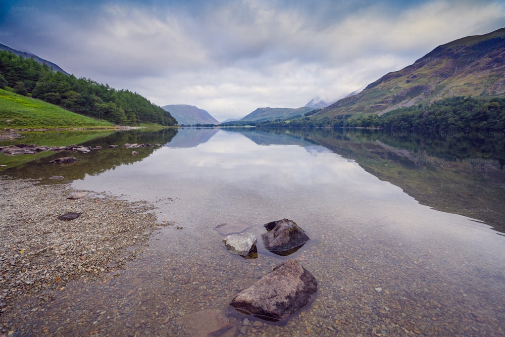 a body of water surrounded by mountains and trees