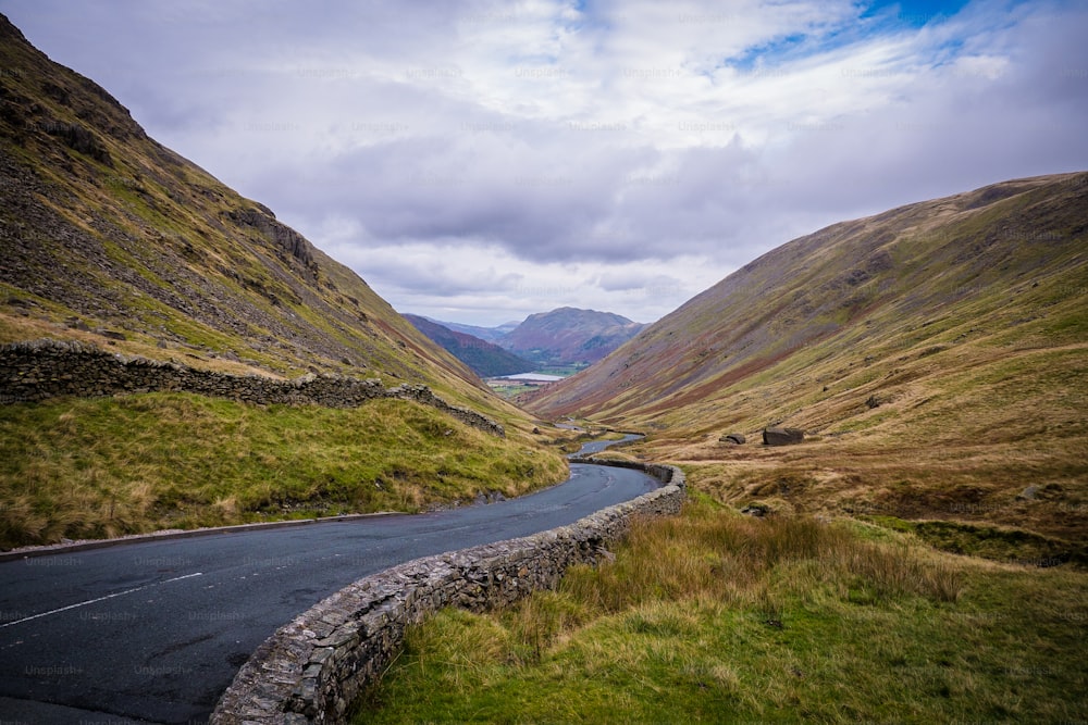 a winding road in the middle of a valley