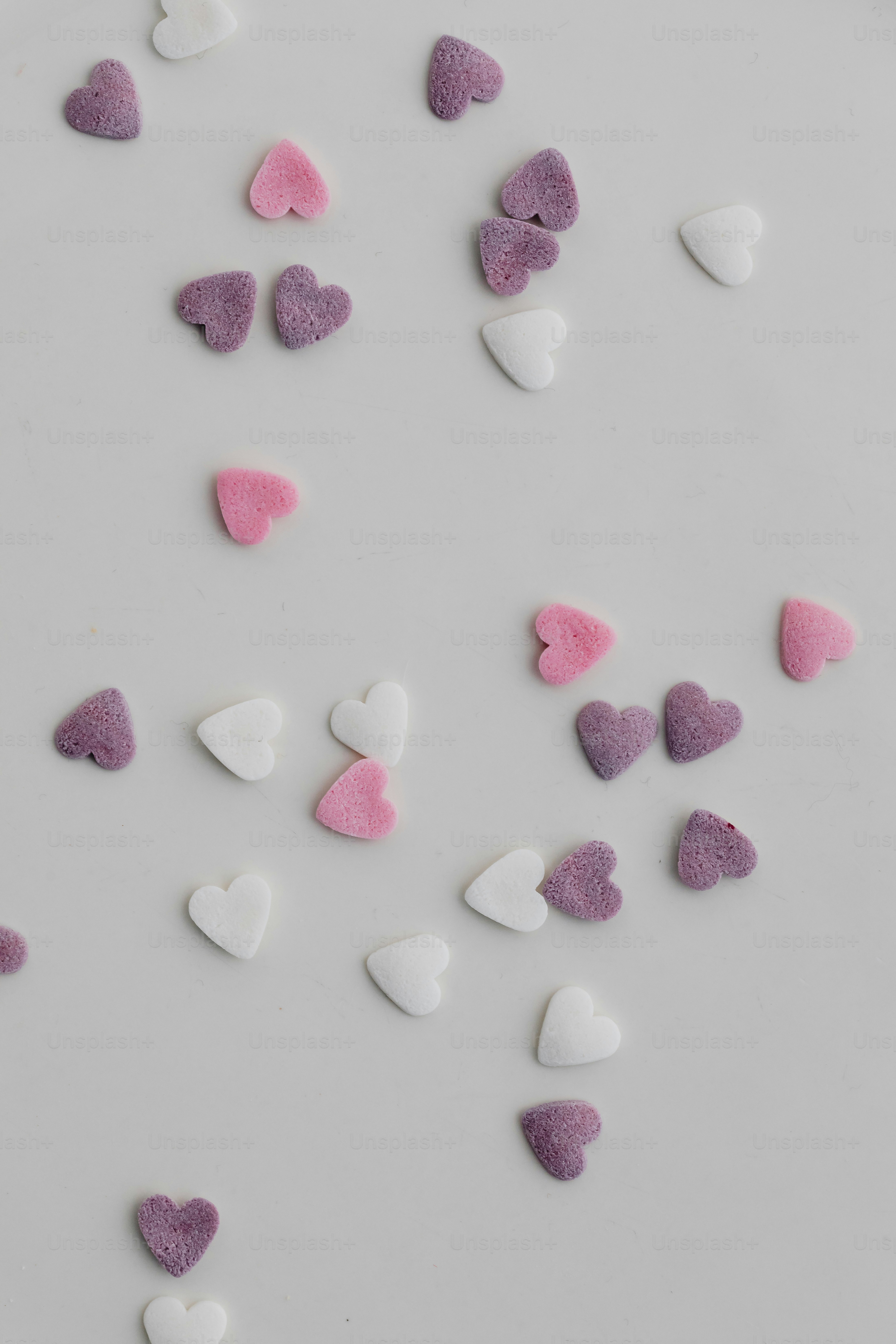 a white plate topped with lots of pink and white hearts