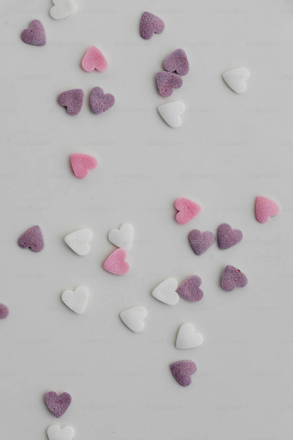a white plate topped with lots of pink and white hearts