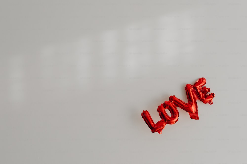 the word love spelled out of candy on a white surface