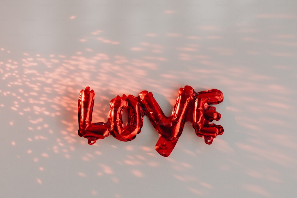 the word love spelled out of foil balloons