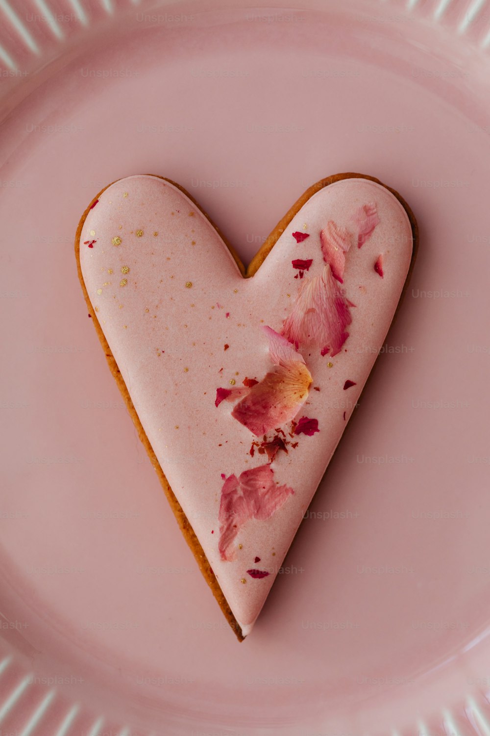 a heart shaped cookie on a pink plate