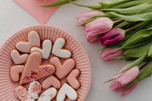 a pink plate with hearts and flowers on it