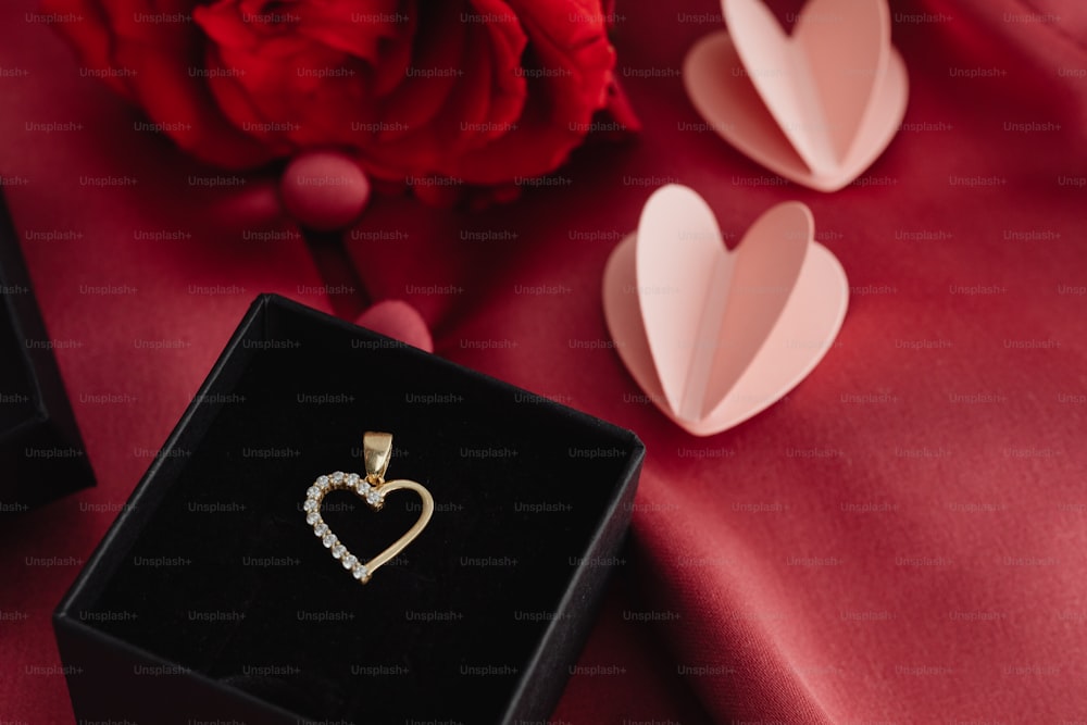 a heart shaped diamond pendant in a black box