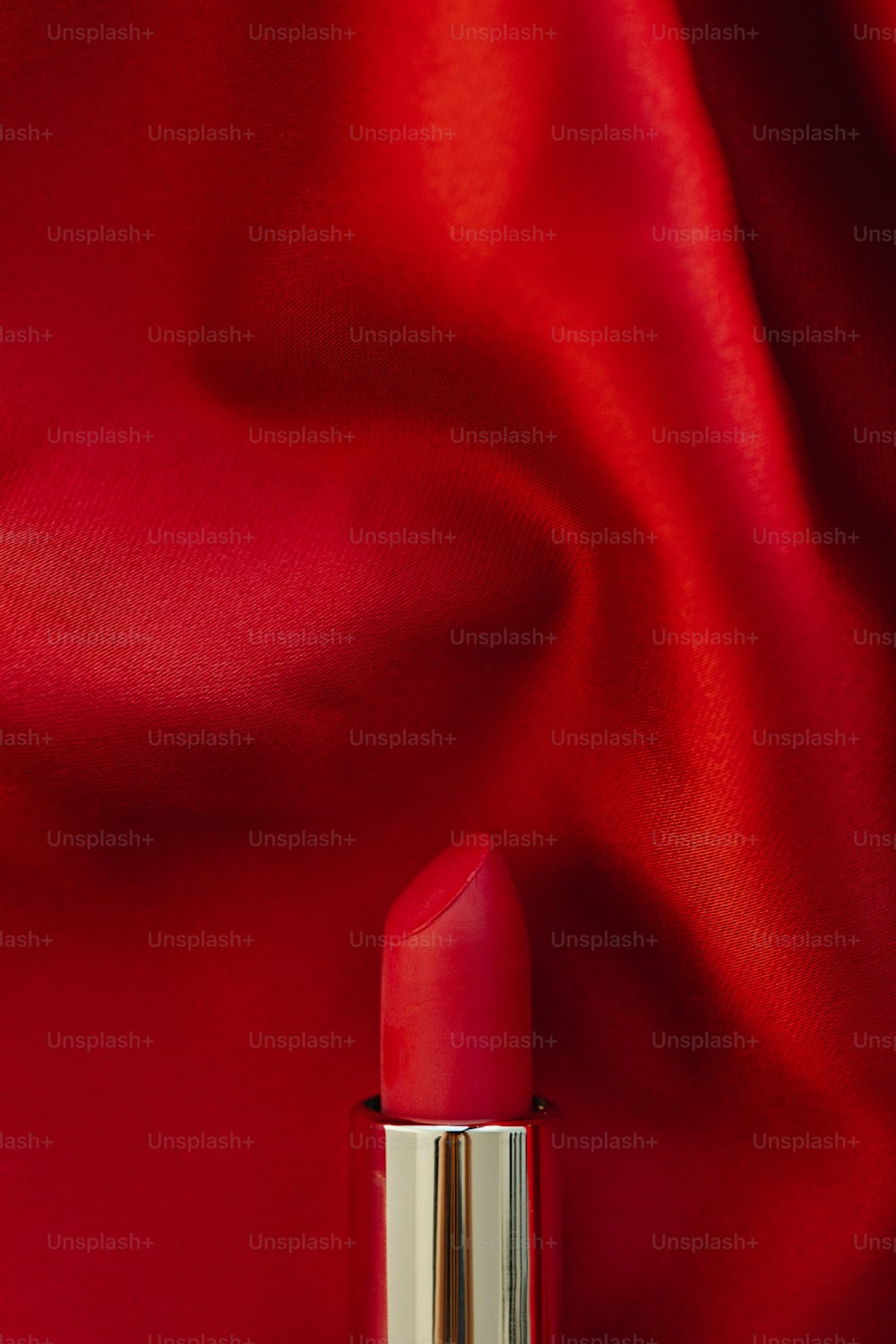 a close up of a lipstick on a red background