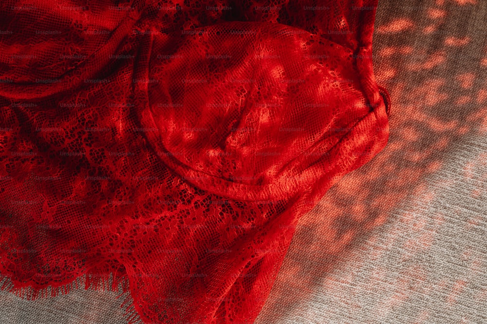 a close up of a piece of red lace