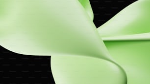 a close up of a green ribbon on a black background