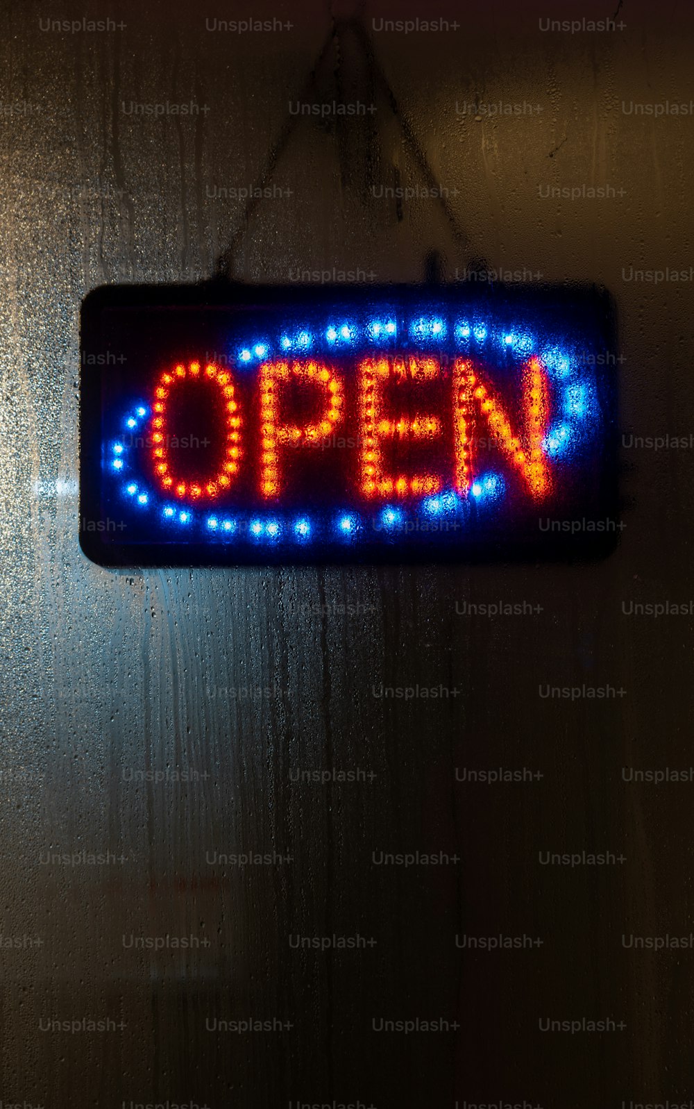 a sign that says open hanging on a wall
