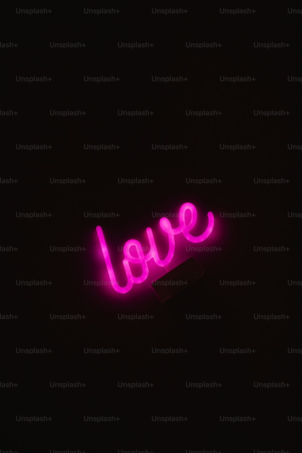 a neon sign that says love in the dark