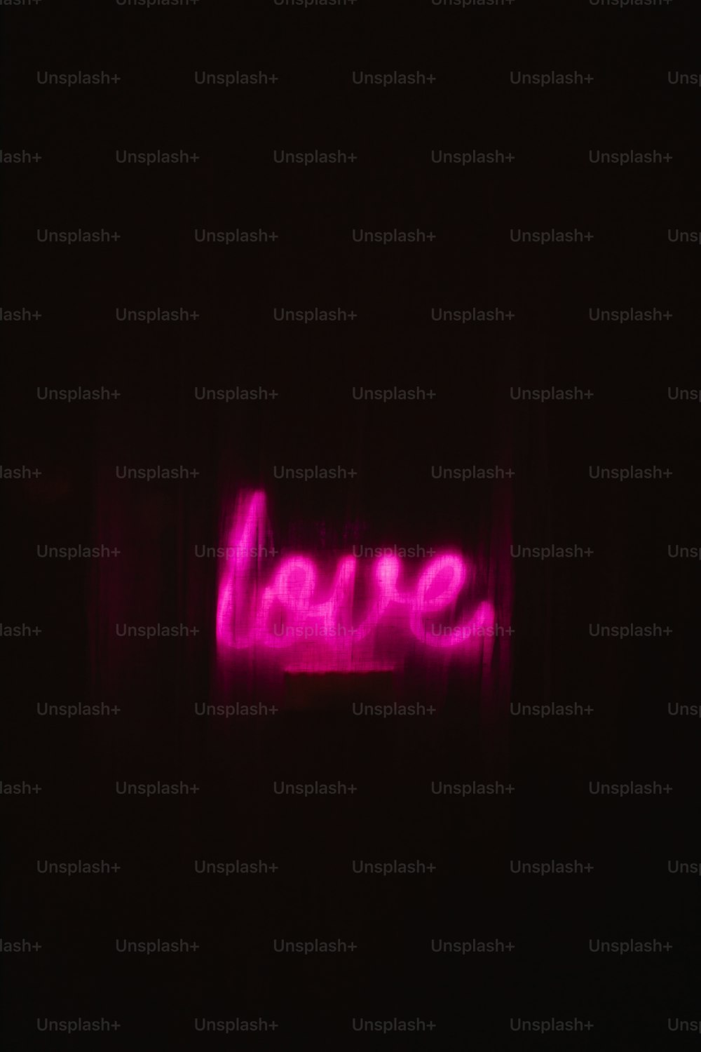 a neon sign that says love in the dark