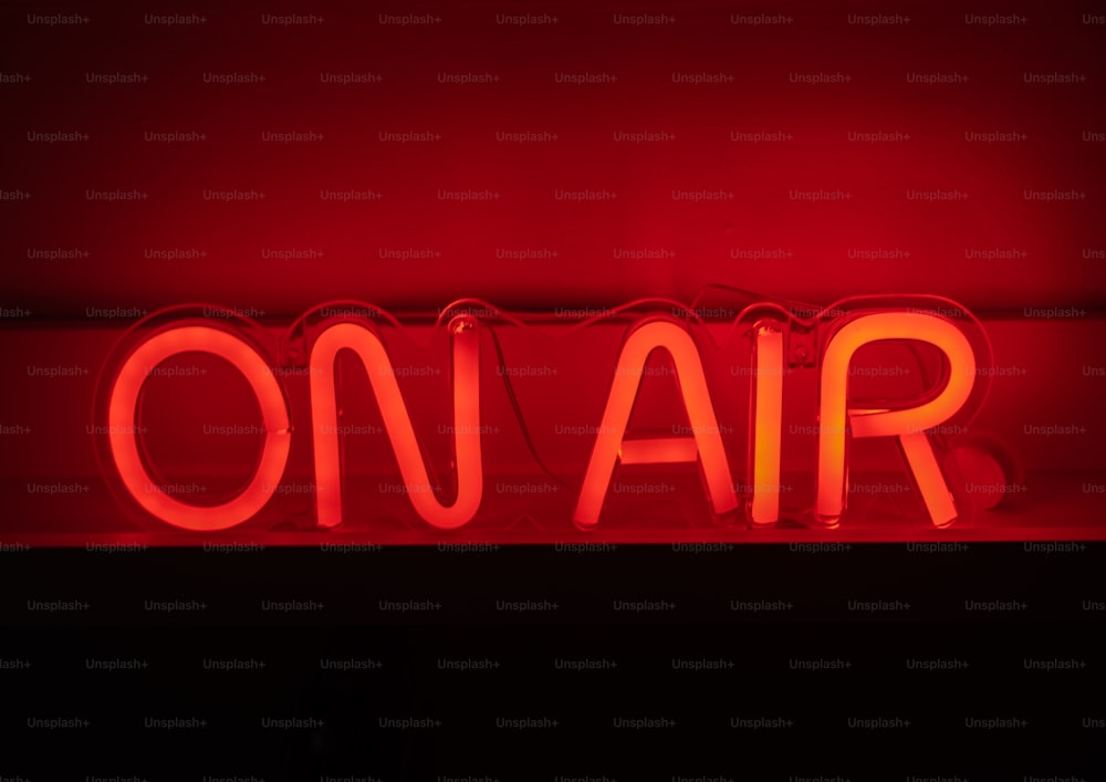 a red neon sign that says on air