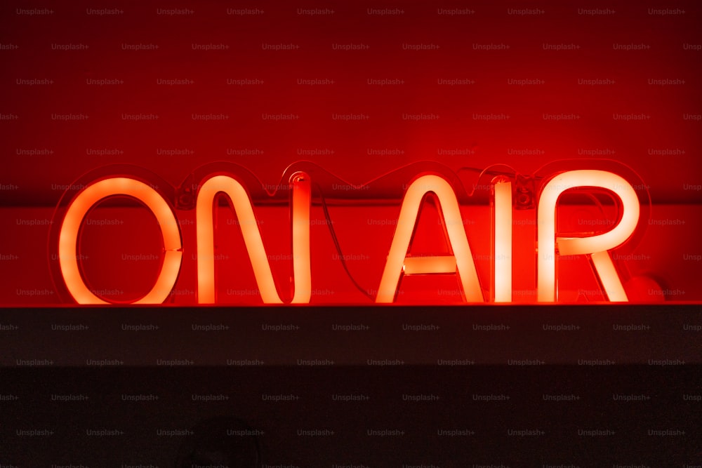 a red neon sign that says on air