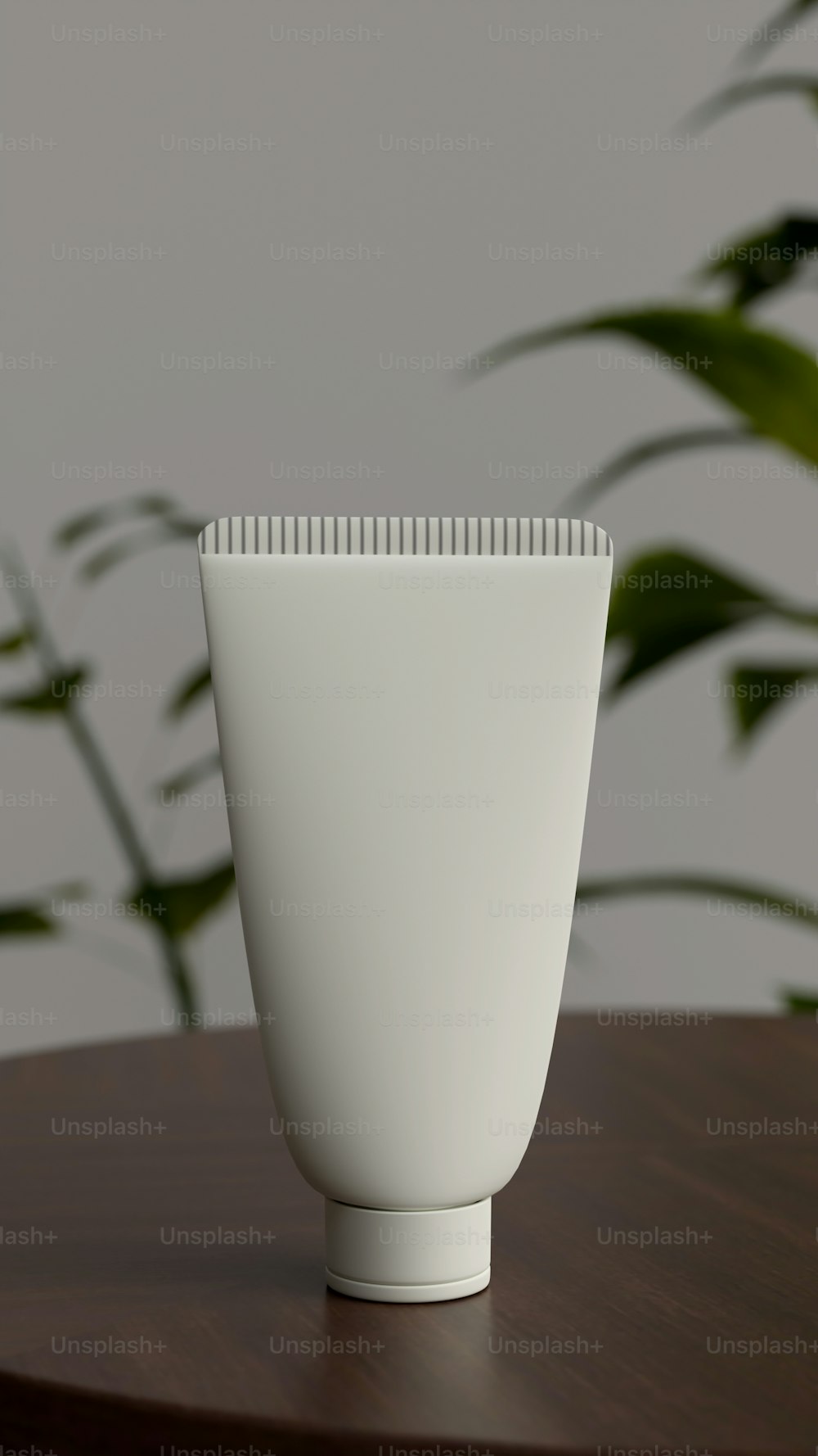 a white vase sitting on top of a wooden table