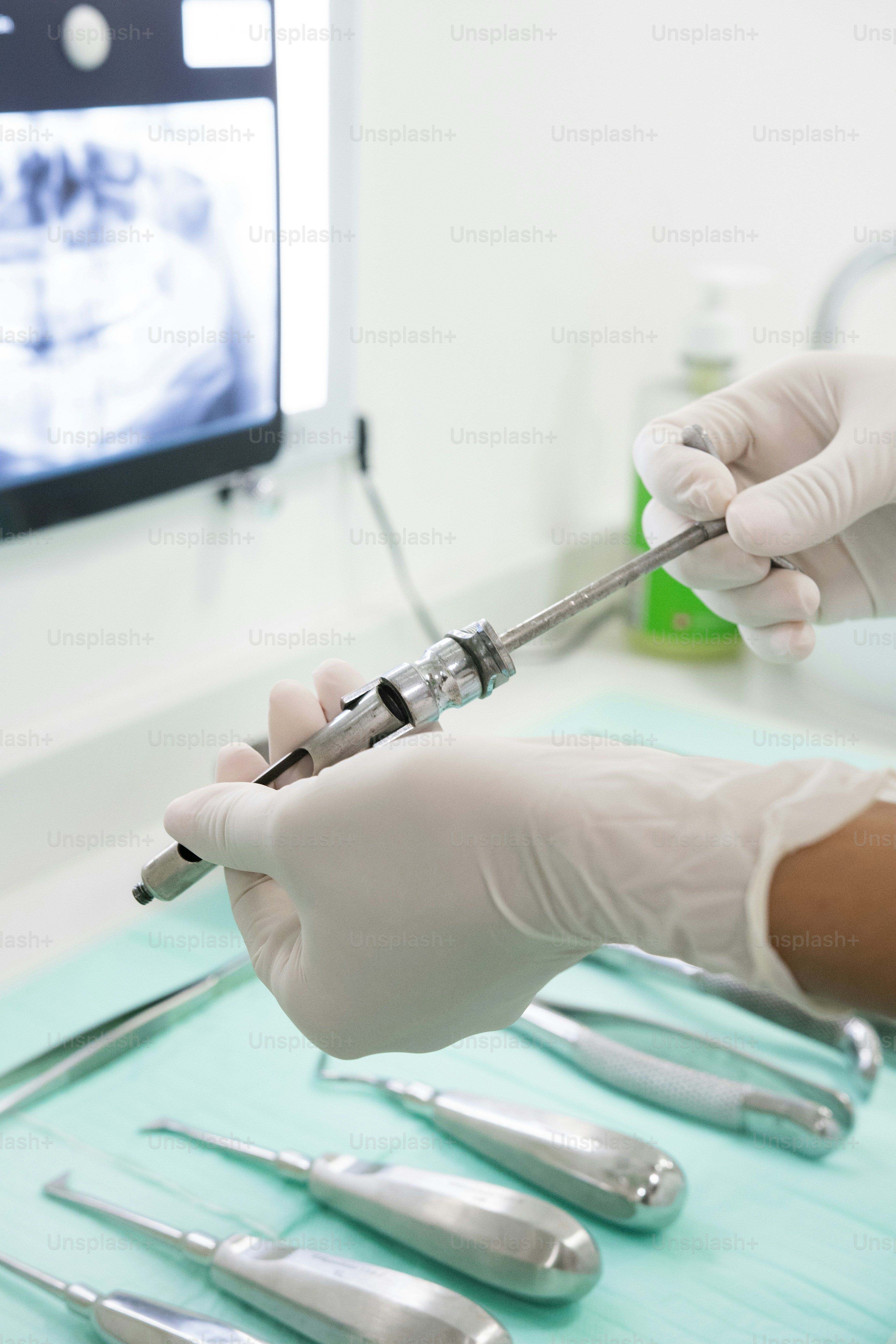 a person in white gloves and gloves holding a tool