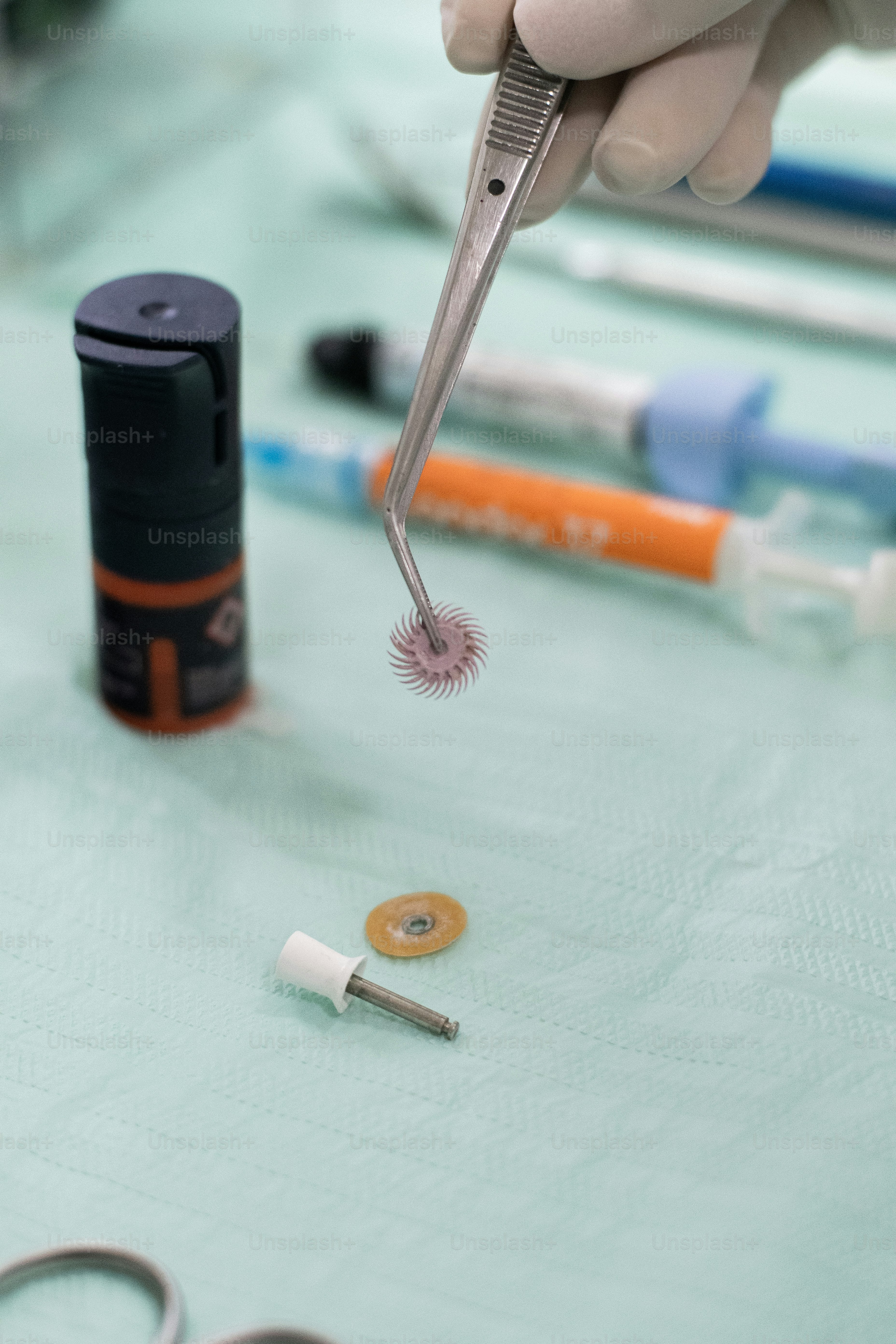 a person holding a pair of scissors and a pair of scissors