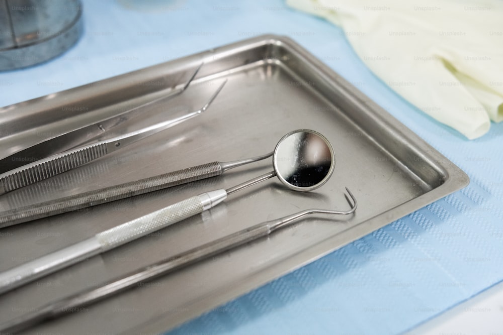 a metal tray with a spoon and a spoon rest on it