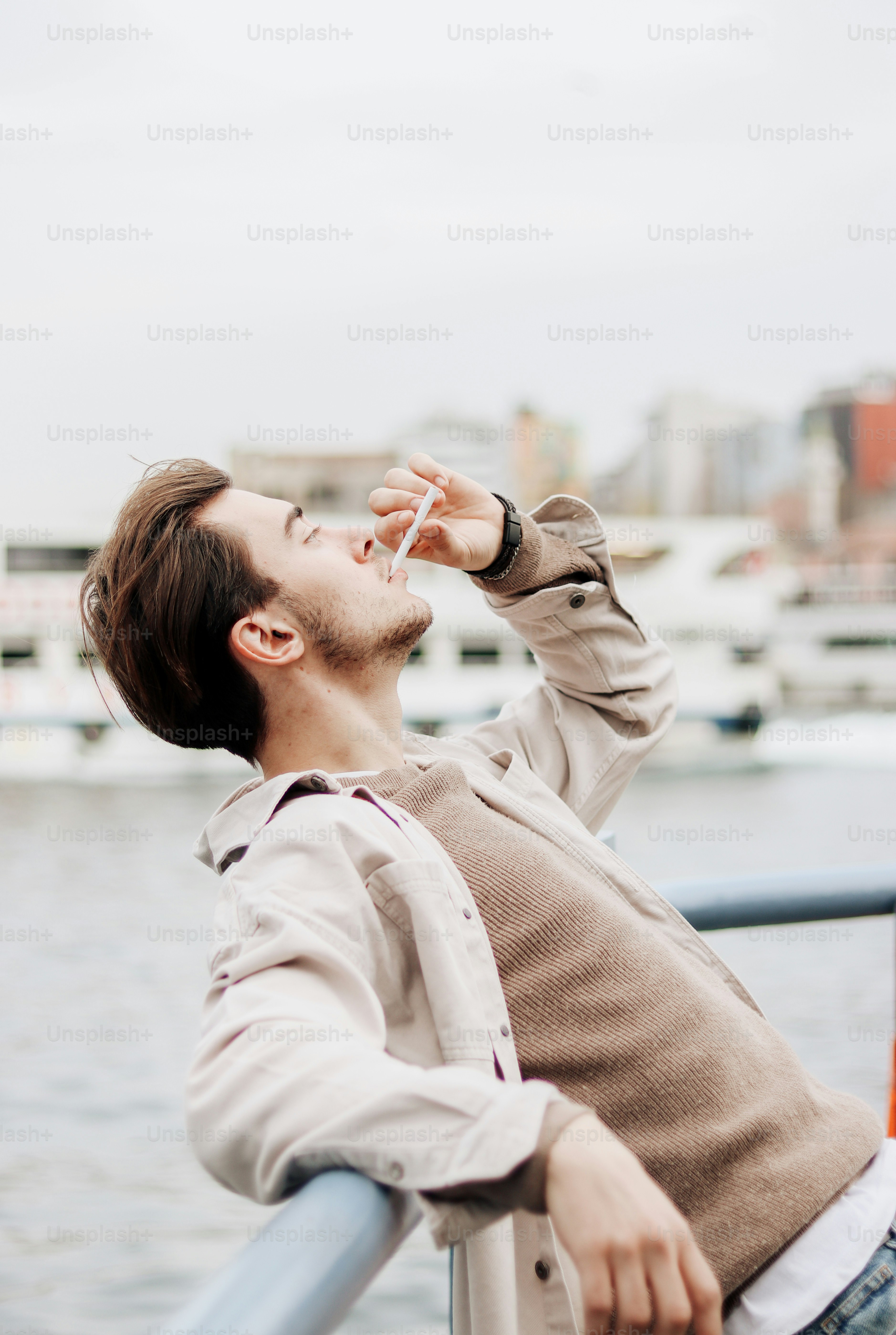 a man leaning on a rail looking up at the sky