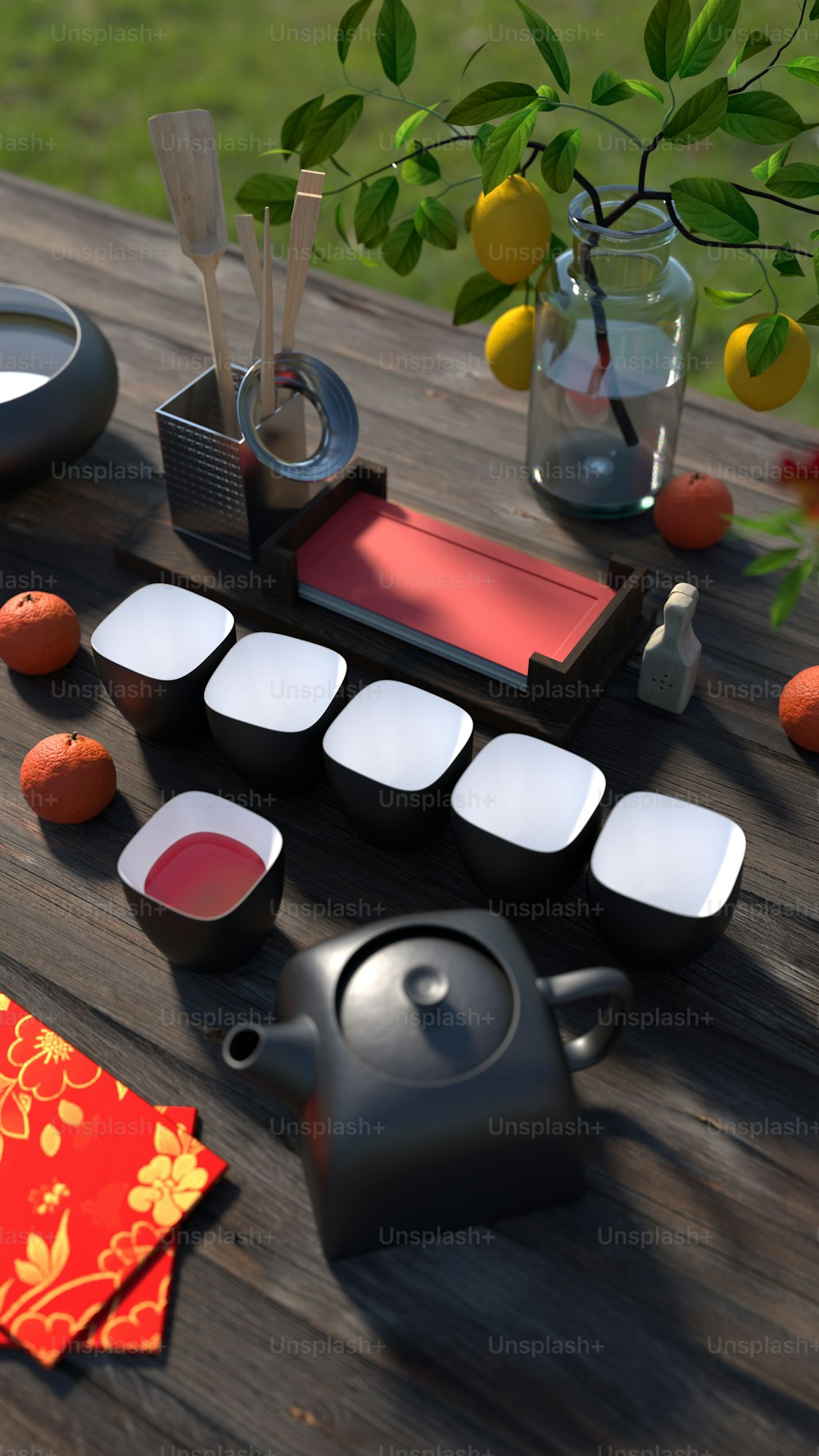 a wooden table topped with a tea set and a vase filled with oranges
