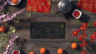 uma mesa de madeira coberta com laranjas e um bule de chá