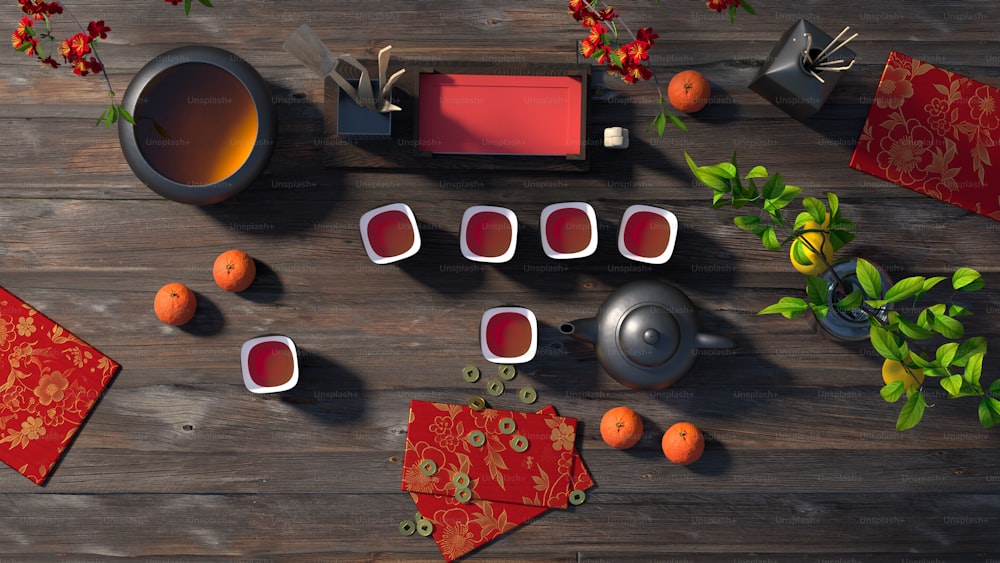 a wooden table topped with oranges and cups of tea