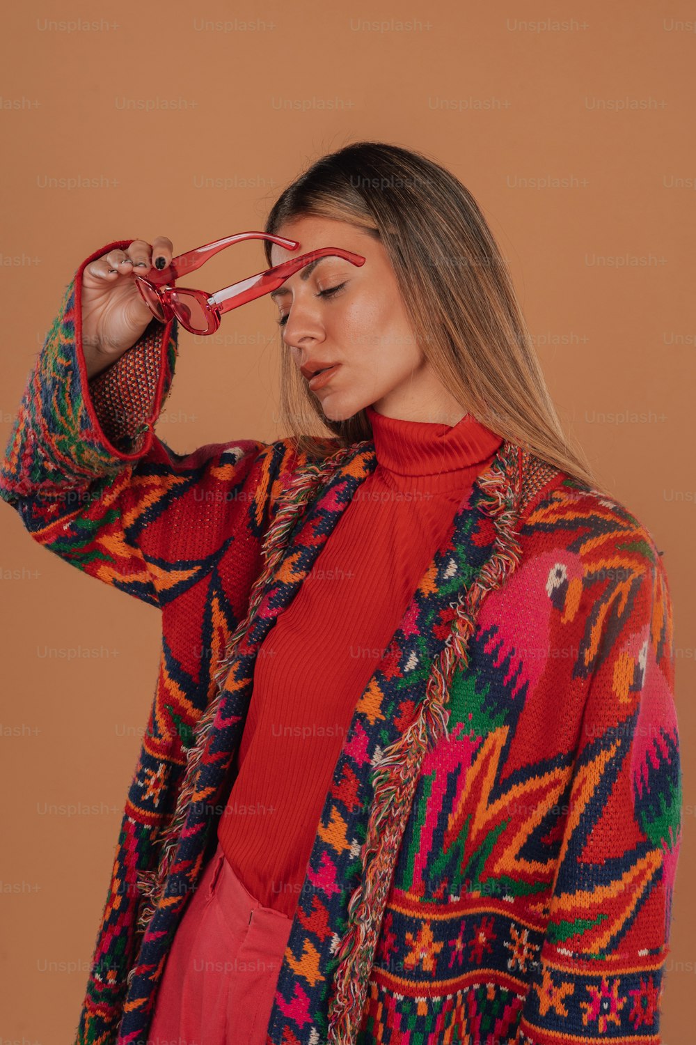 a woman wearing a red sweater and glasses