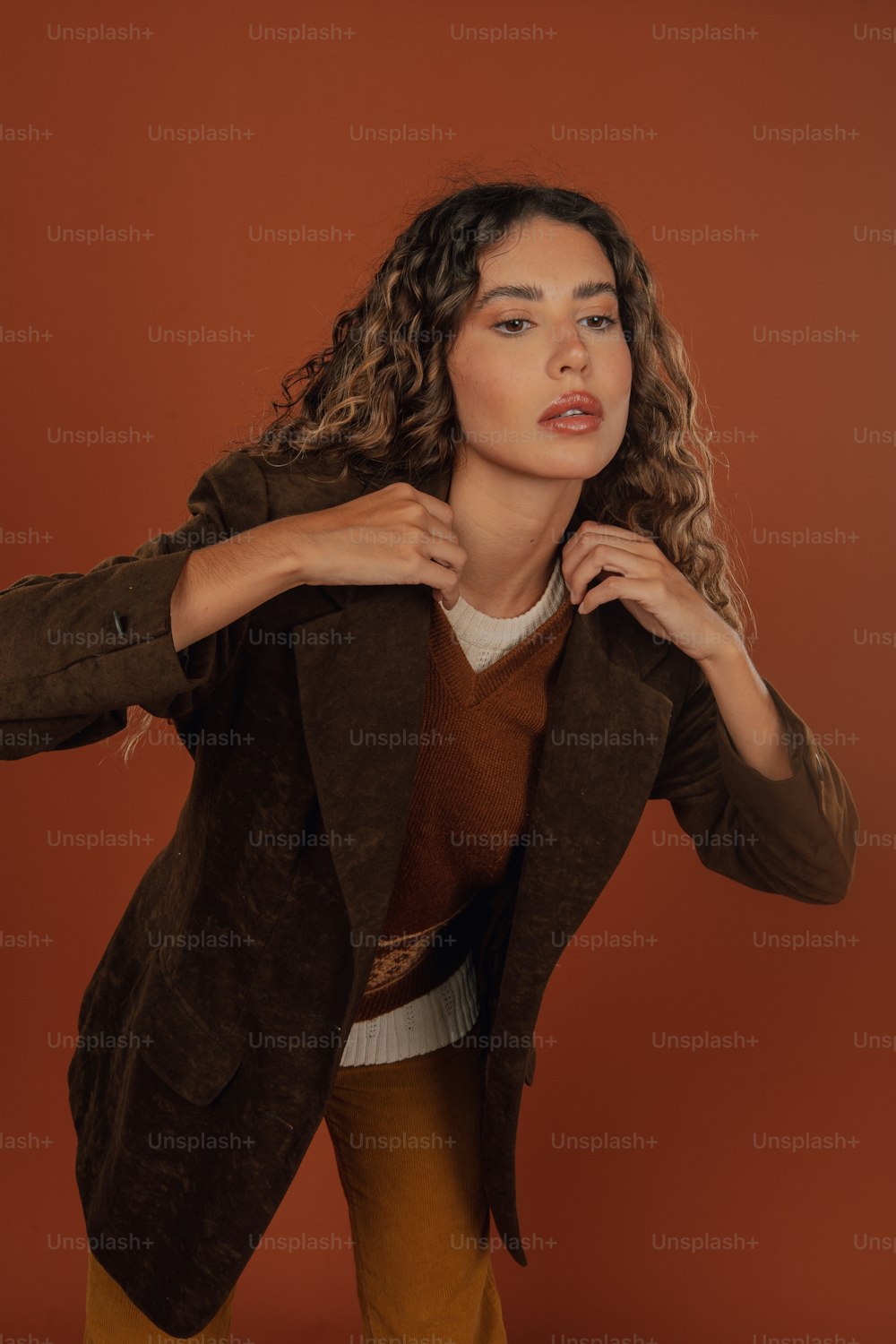 a woman with curly hair is posing for a picture