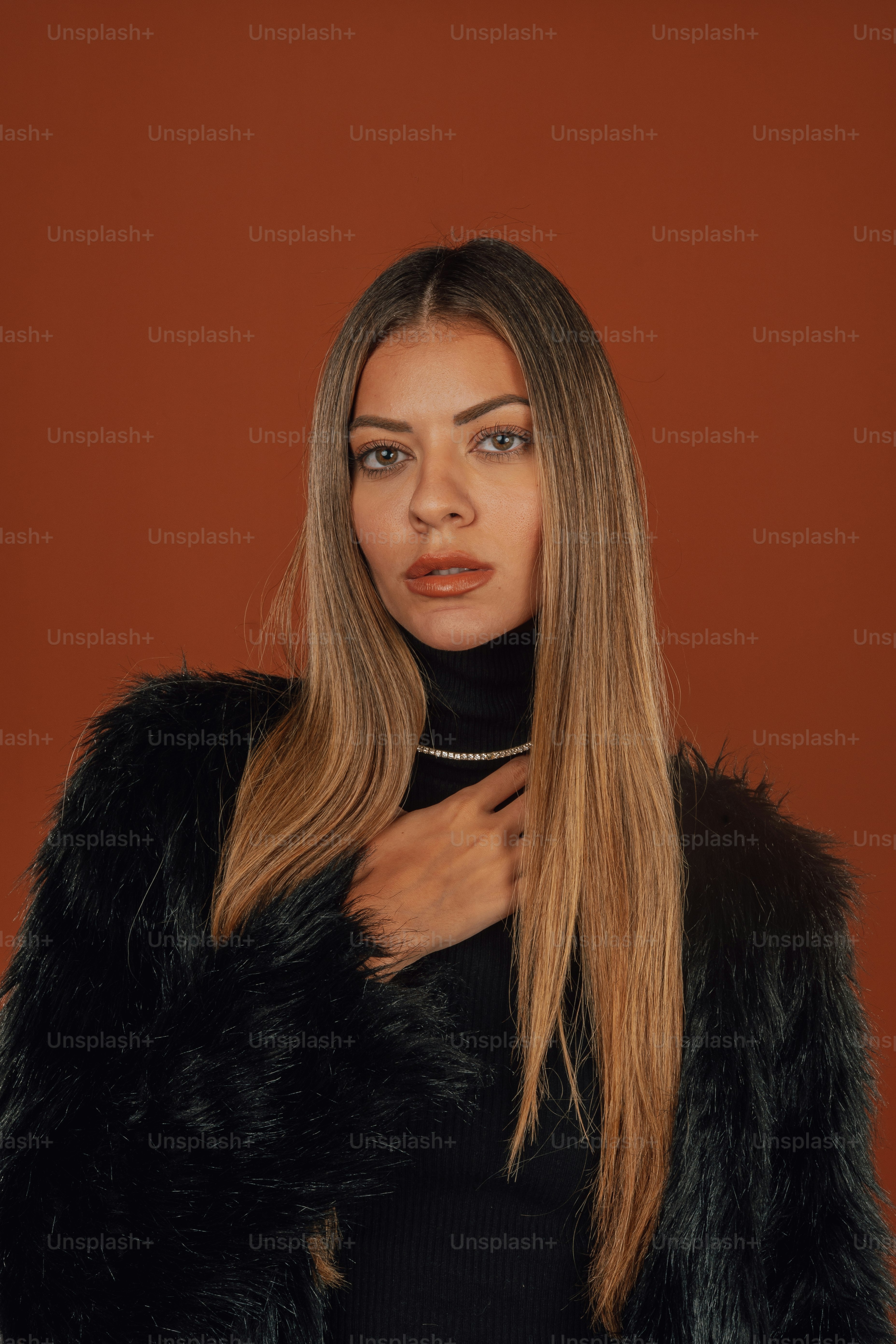 a woman with long hair wearing a fur coat