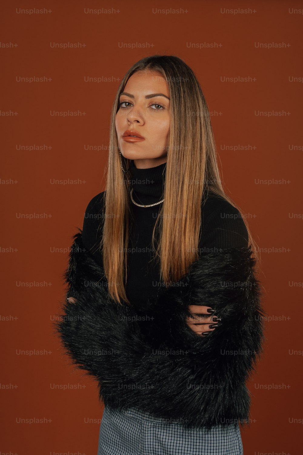 a woman with long hair wearing a black sweater
