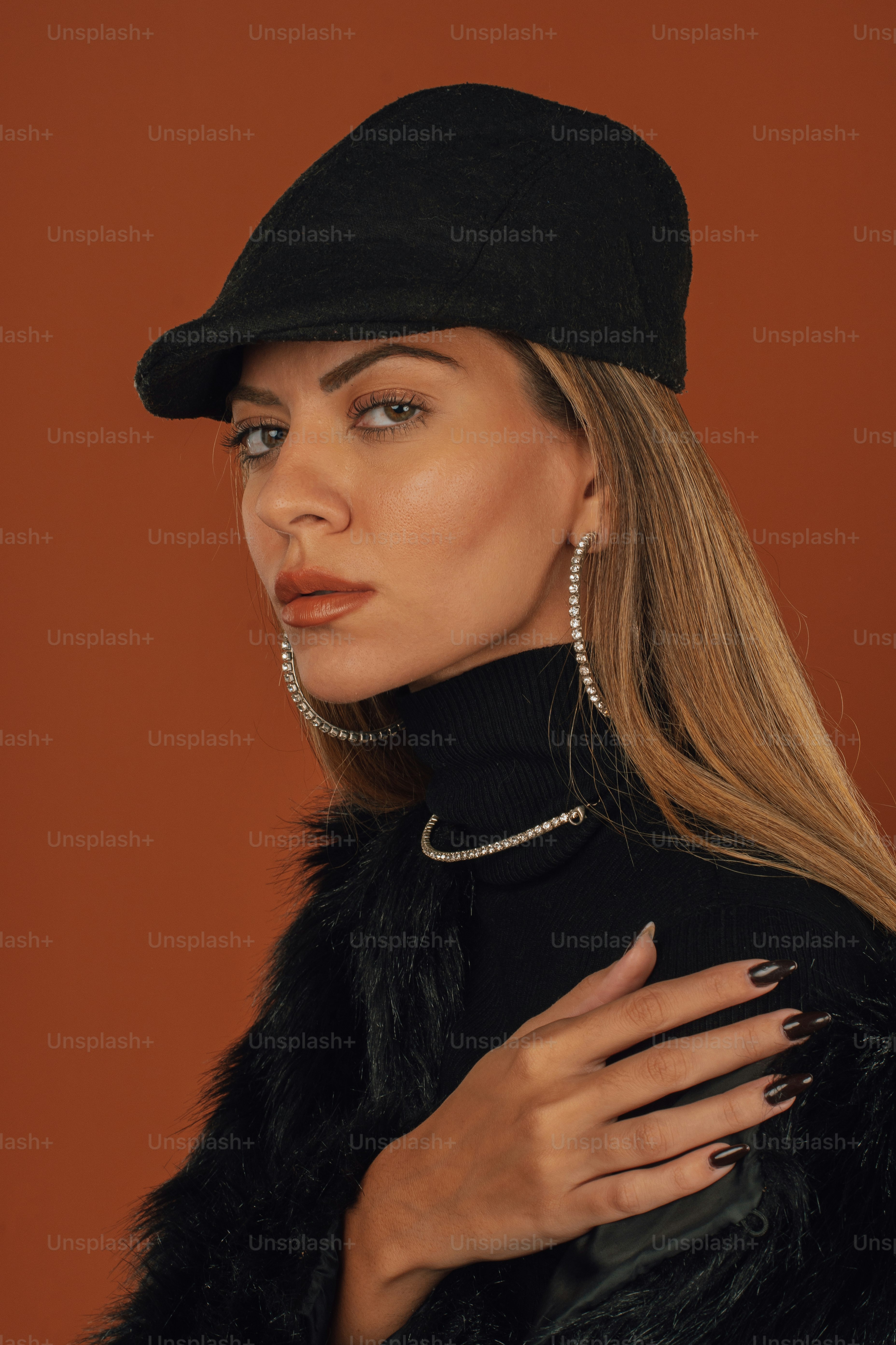 a woman wearing a black hat and fur coat