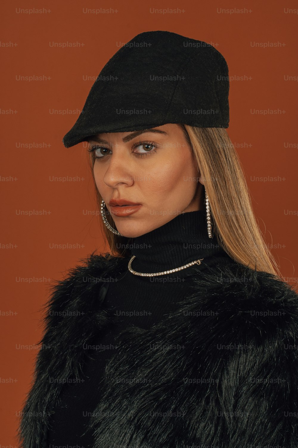 a woman wearing a black hat and fur coat