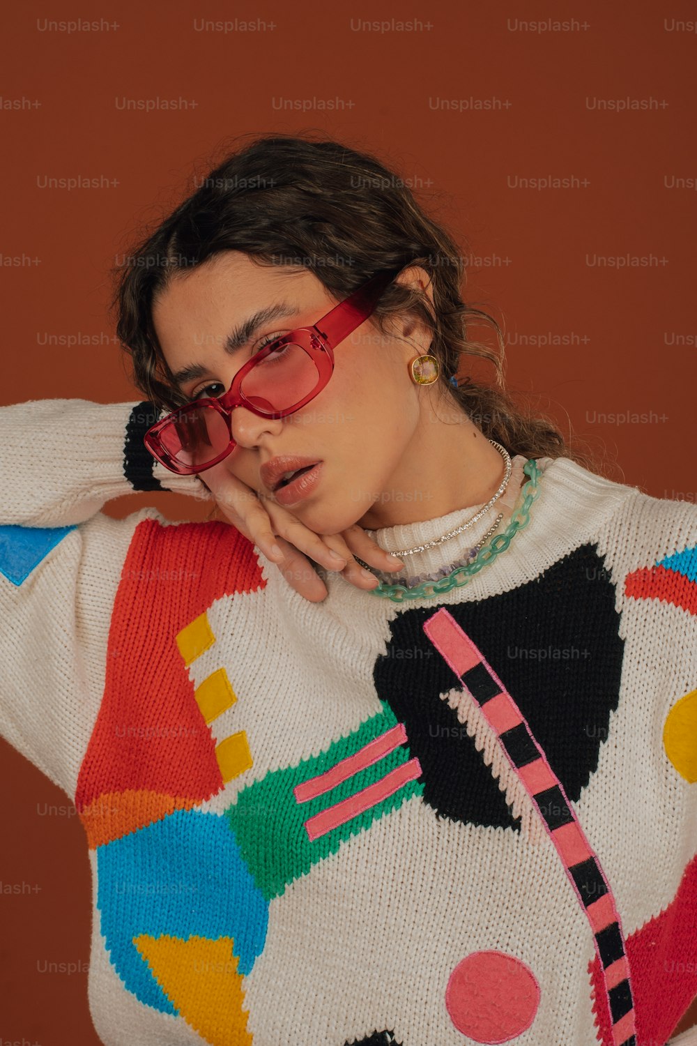 a woman wearing a colorful sweater and glasses