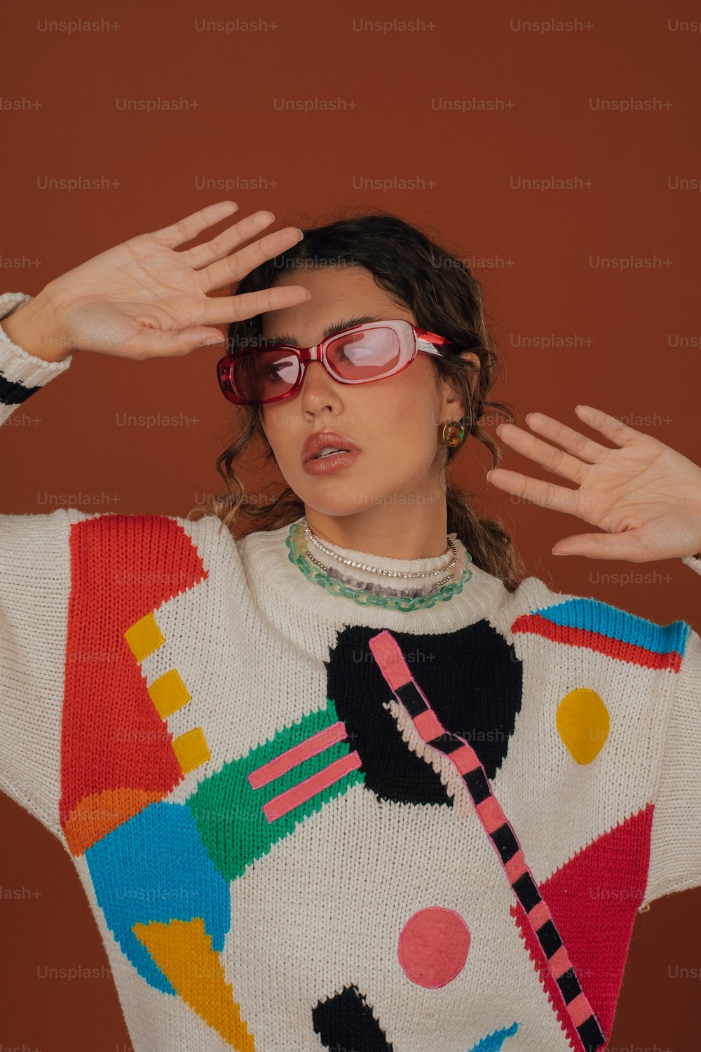 a woman wearing a colorful sweater and sunglasses