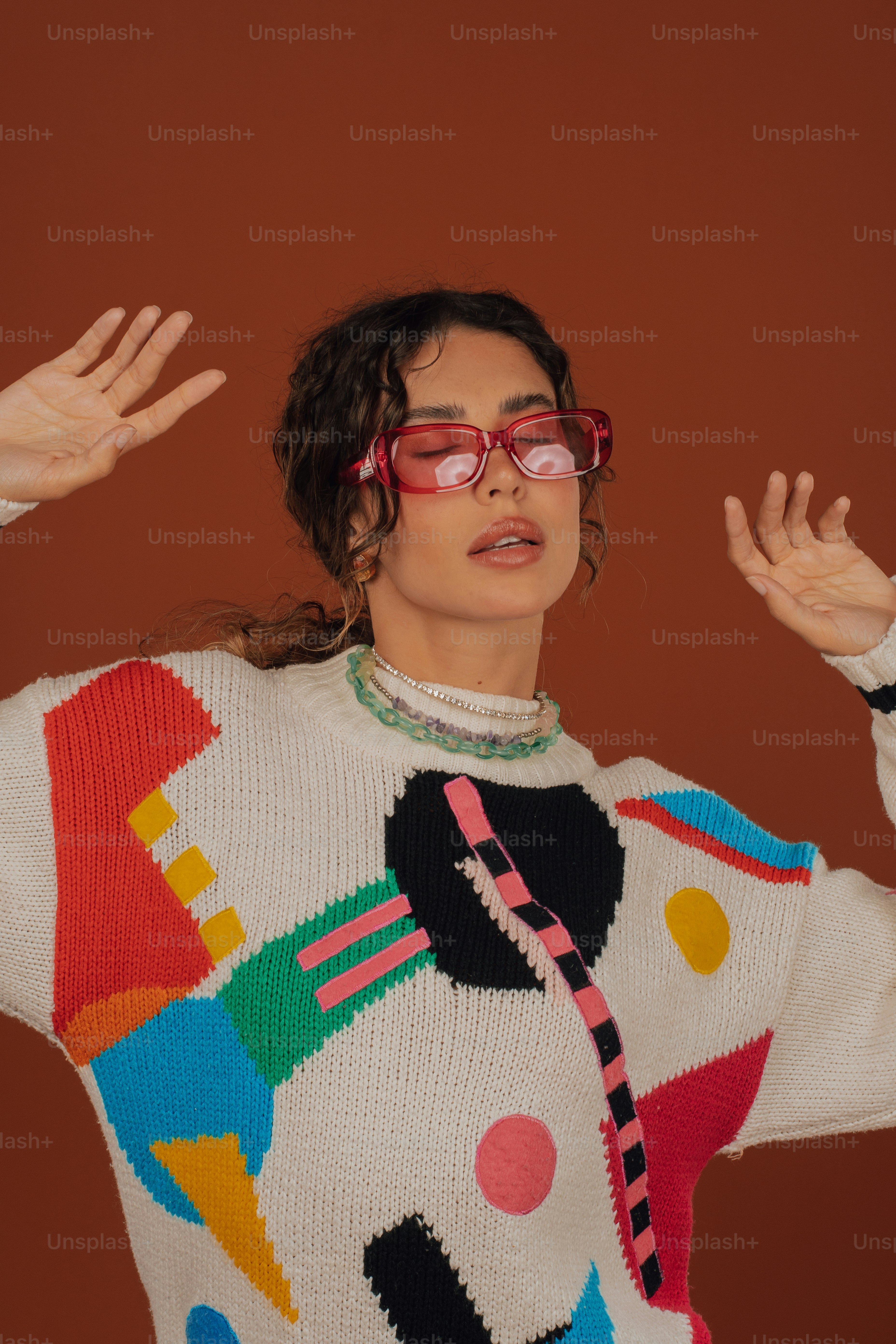 a woman wearing a colorful sweater and glasses