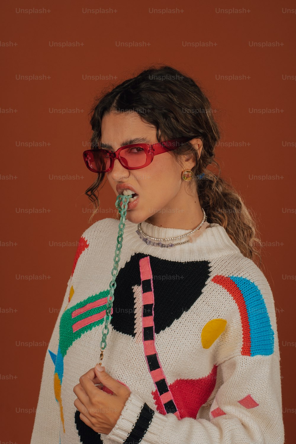 a woman in a colorful sweater and red glasses