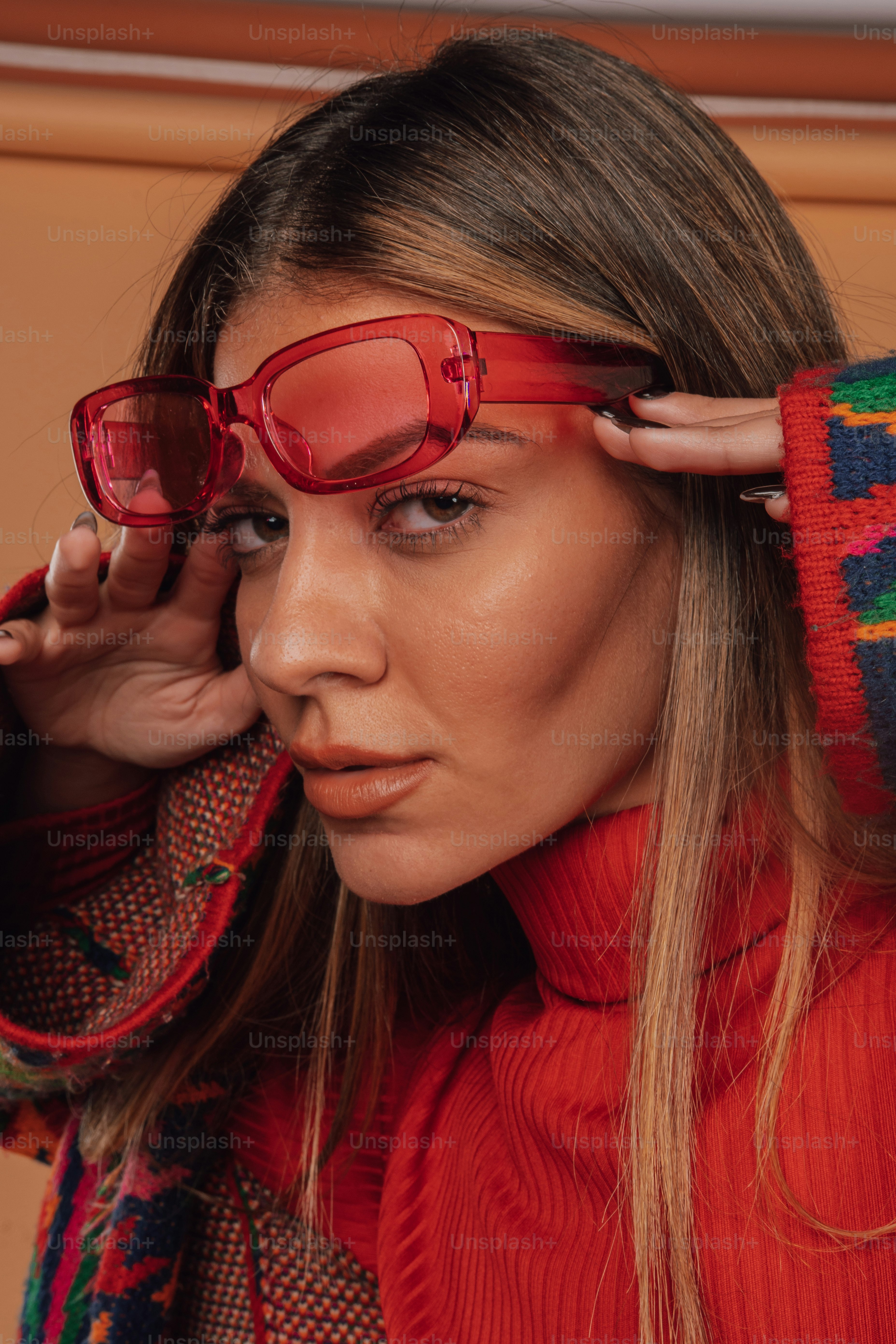 a woman wearing red glasses and a red sweater