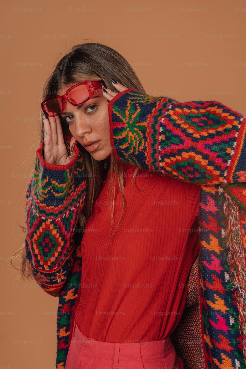 a woman in a red dress and a colorful sweater
