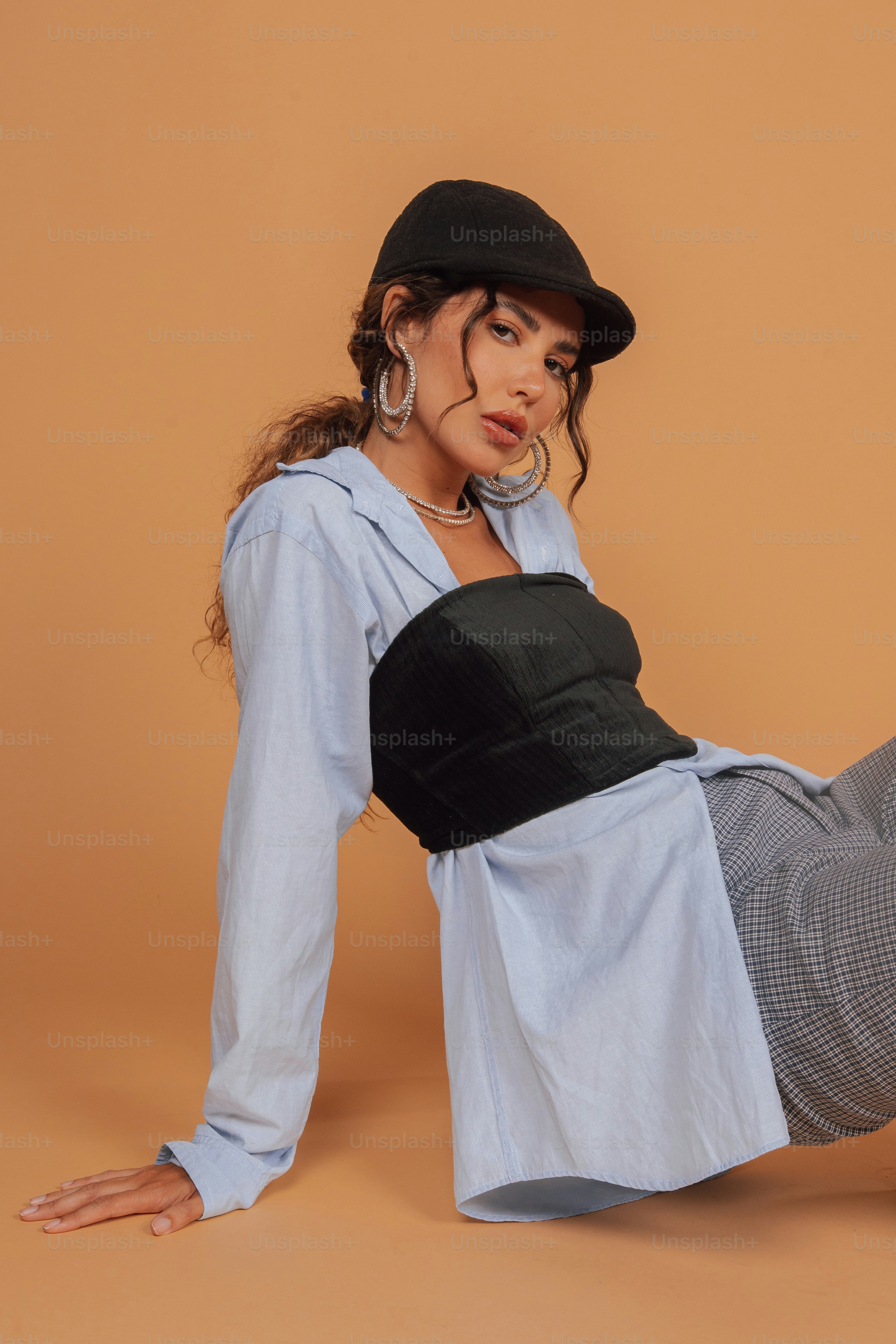 a woman in a dress and hat posing for a picture