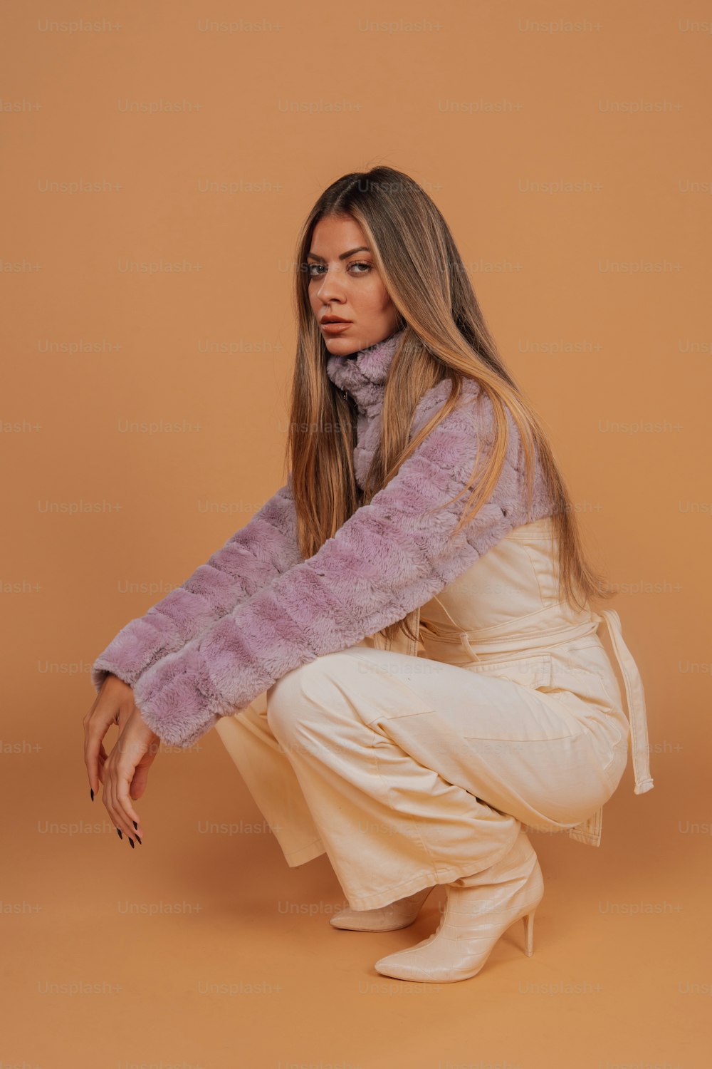 a woman in white pants and a purple scarf